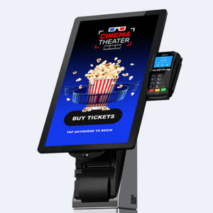 Produktbillede af ELO I-Series 4, 10" touch-display med betalingsterminal og stregkodelæser vises monteret i en biograf. Interaktiv touchskærm til erhvervsløsninger.